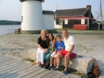 Heather's parents, Rick and Barb, with her children, Ashley and Justin, at Mystic Seaport, The lighthouse is in the background.