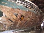 Ashley and Justin peer out from the bones of an un-restored ship, the Australia