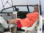 Rick dozing in the captain's chair on his fishing boat, the HONEYMAYI.
