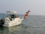 Justin and Grandpa jump off the side of the boat