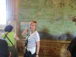 Our guide showing of an ancient map of Italy.